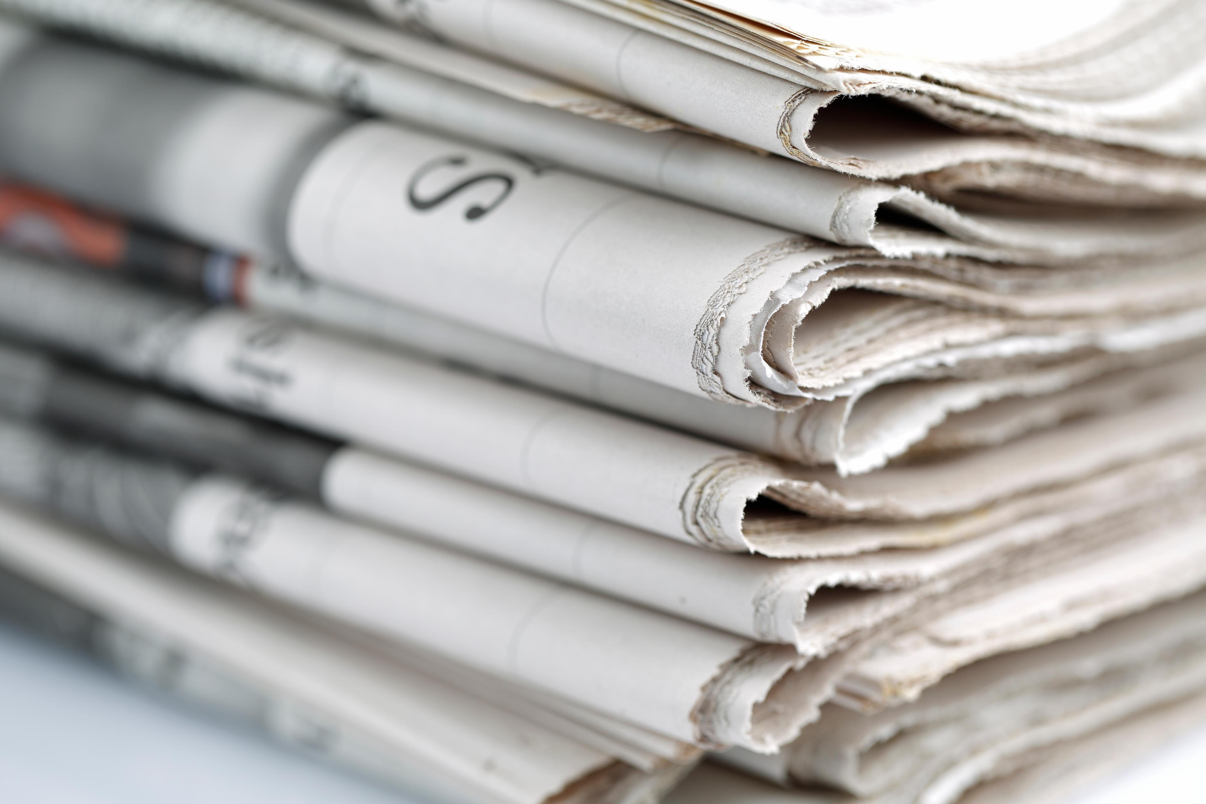 stack of folded newspapers