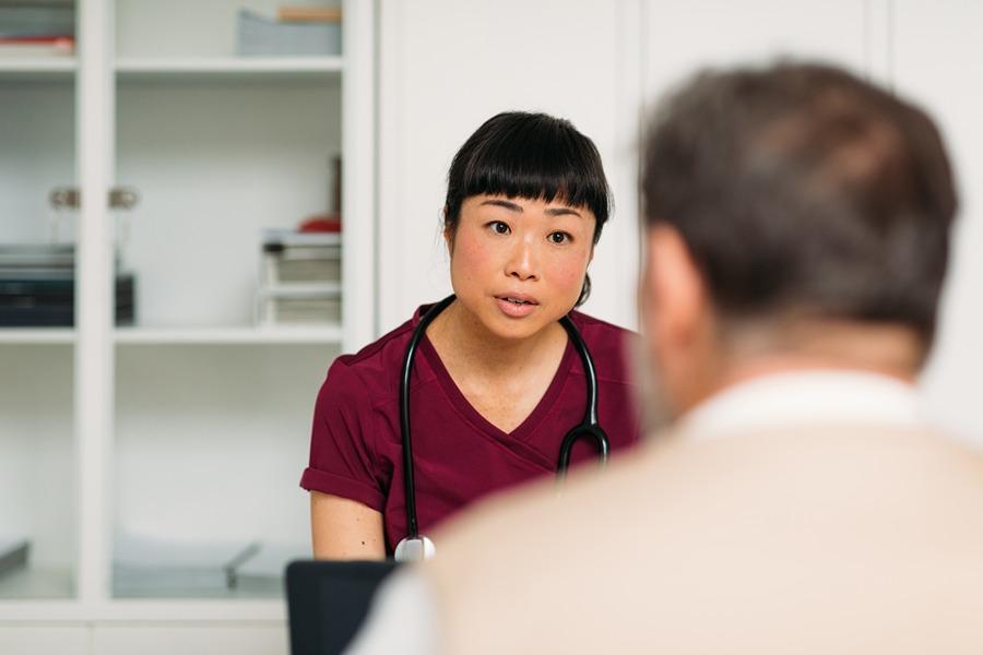 female nurse speaking to patient across from her